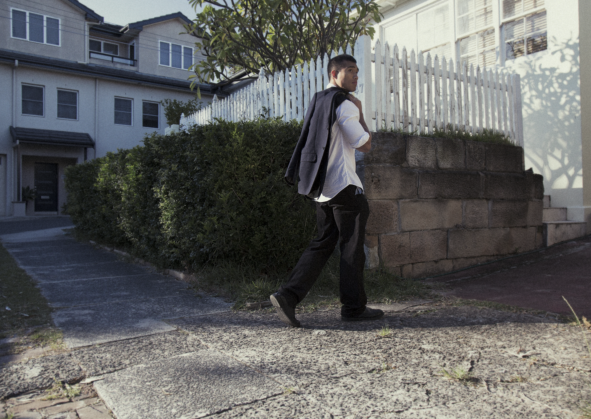 Miguel walking by fence